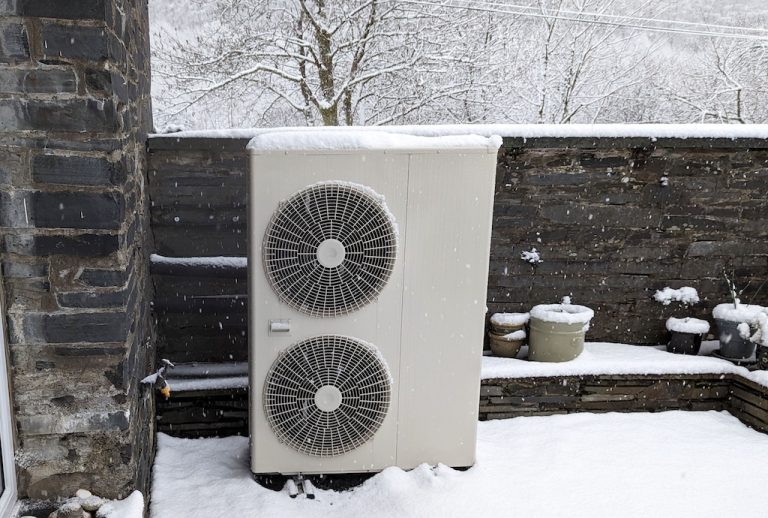 Heat pump condenser in snowy yard